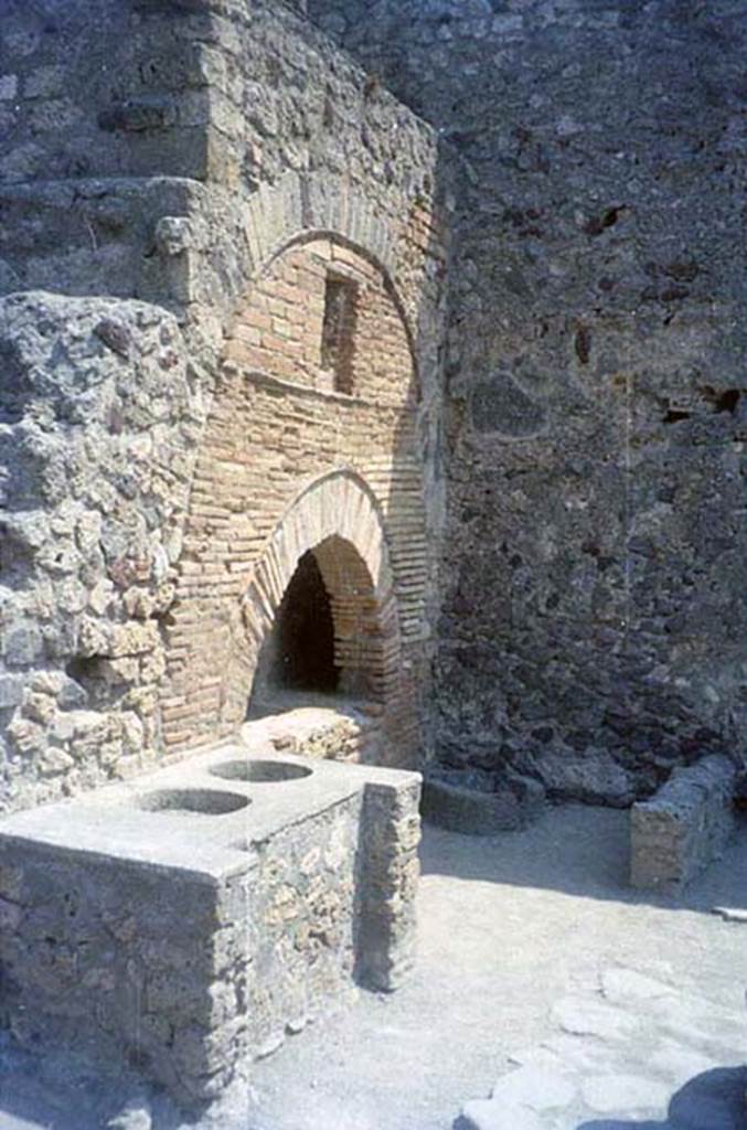 VI.6.17 Pompeii. July 2011. Bench, oven, and mill in bakery. 
Photo courtesy of Rick Bauer.