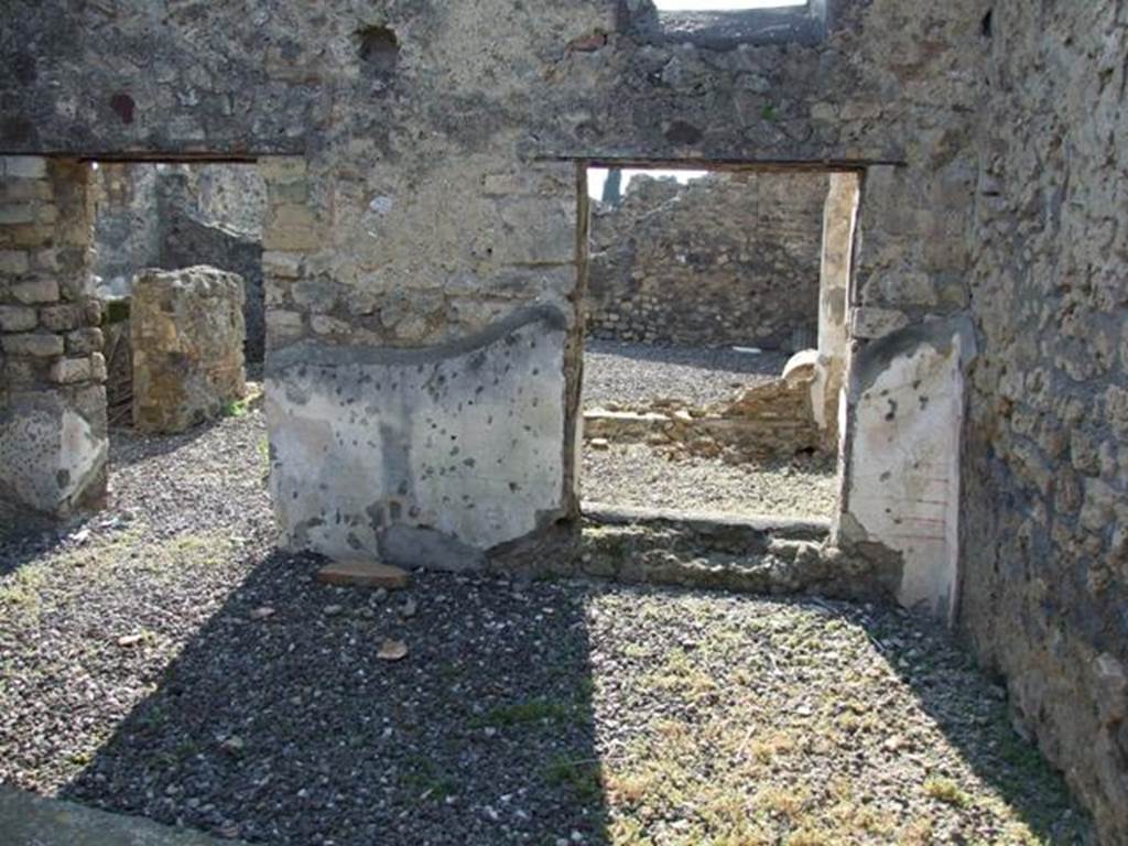 VI.7.1 Pompeii. March 2009.  West wall.
Looking west from triclinium at rear of light-well, into open tablinum (left) and light-well (right).
In  the corner next to the window to the light-well, the remains of the painted decoration can still be seen comprising of simple red lines on white background.