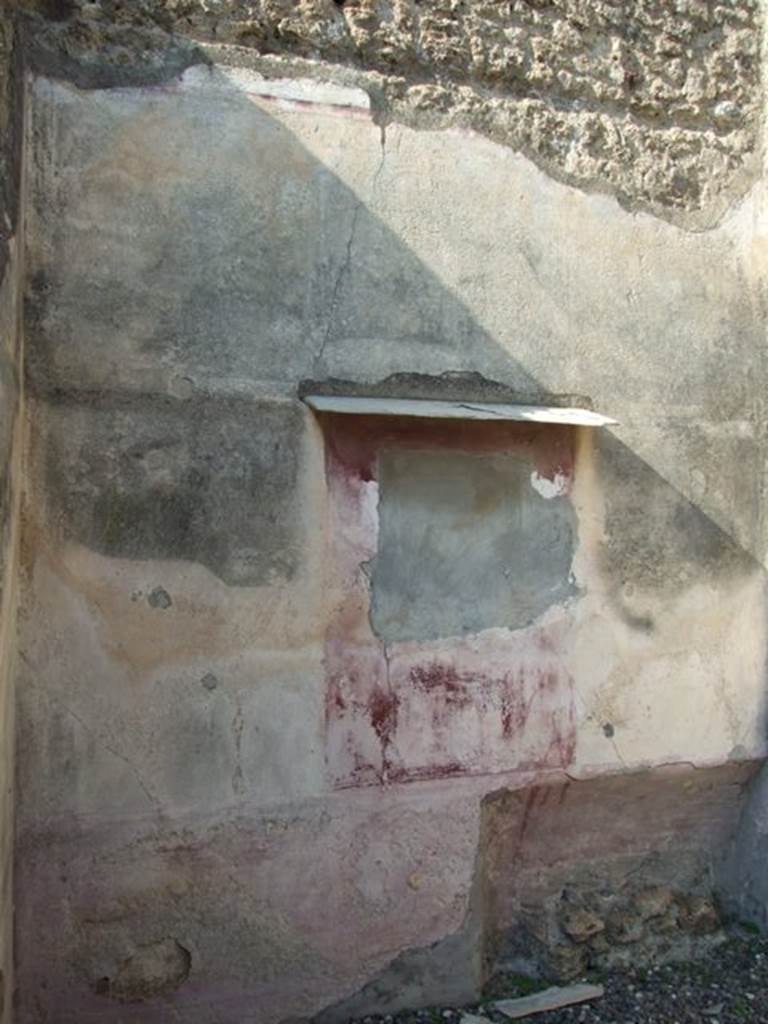 VI.7.3 Pompeii. March 2009. Room 4, remains of painting on north wall with bed recess below.  
The zoccolo/lower wall was violet as was the central panel with the painting. The two side panels were discoloured.
