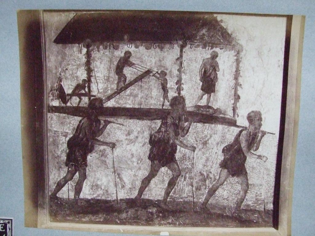 VI.7.9 Pompeii. Wall painting of the Procession of the Carpenters.   
Originally found on pilaster between entrances VI.7.8 and VI.7.9.
Now in Naples Archaeological Museum. Inventory Number 8991.
Old undated photograph courtesy of the Society of Antiquaries, Fox Collection.