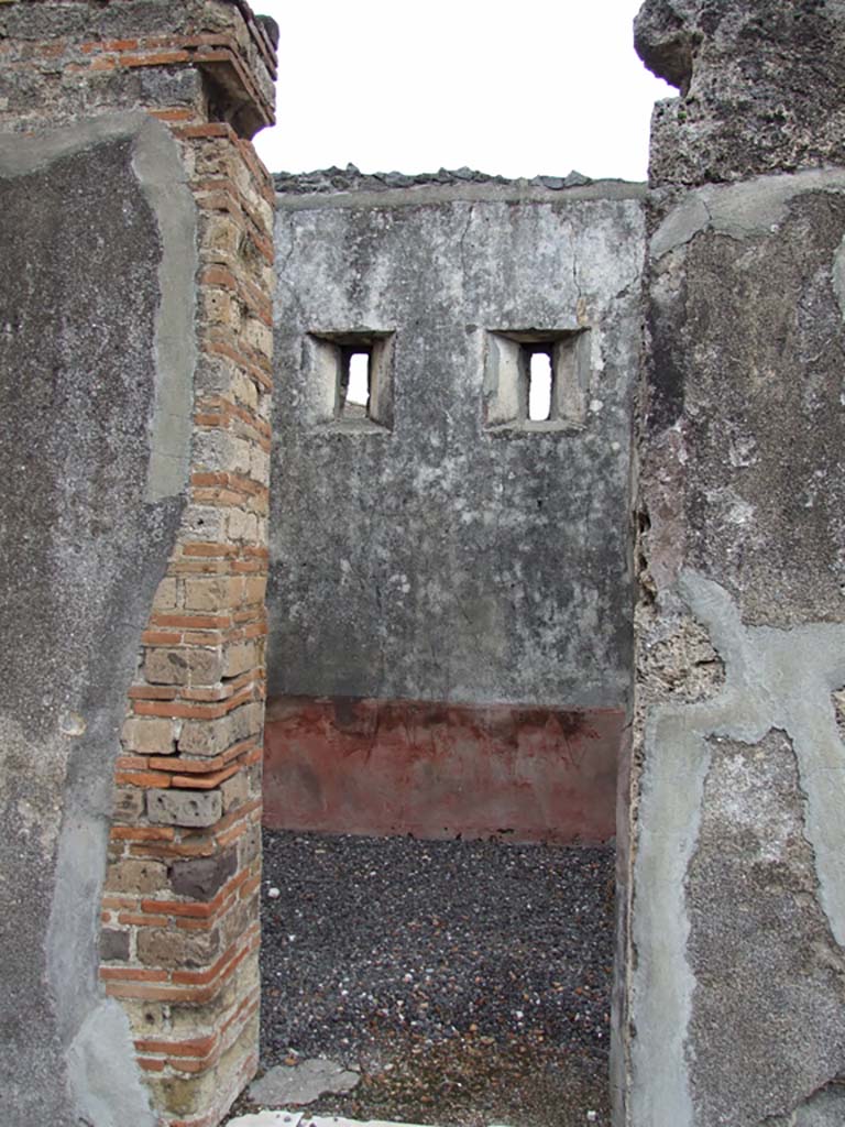 VI.7.19 Pompeii. December 2006. Doorway to cubiculum on north side of entrance corridor, looking east.
This room was decorated with a red plinth and red dado. On each dado were painted jugs.
On the north wall was a painted golden wine-glass shaped crater, with two painted panels with plants. 
On the east wall was a painted yellow jug.
On the south wall was a painted golden wine-glass shaped crater.
Above the red dado were yellow panels, divided by painted architecture.
See Bragantini, de Vos, Badoni, 1983. Pitture e Pavimenti di Pompei, Parte 2. Rome: ICCD. (p.153)