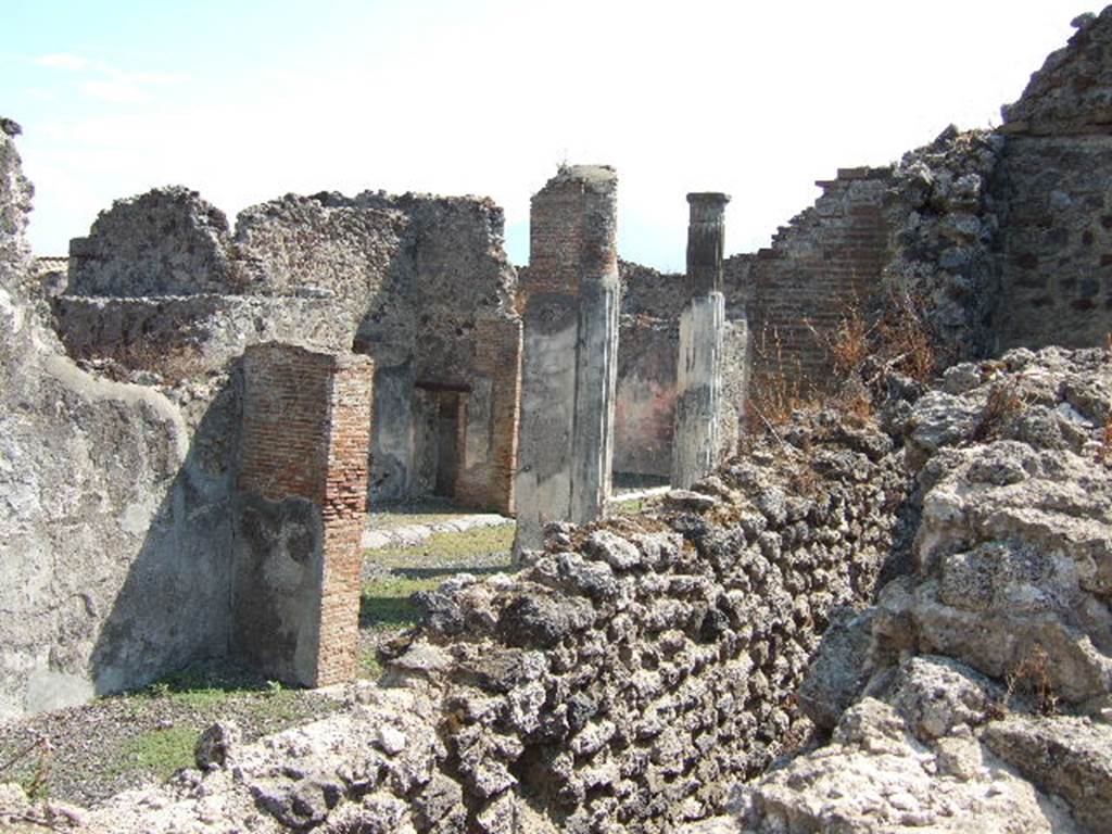 VI.7.20 Pompeii, September 2005. Looking south-east across triclinium towards peristyle.
On the left would be the east wall of the triclinium. Between the walls, in the lower right, would be east wall of the corridor leading to the kitchen and latrine. In the centre, between the pilasters, the south wall of the small room with the painted medallions can be seen, with doorway into corridor between atrium and peristyle.  Taken over wall in Vicolo della Fullonica.