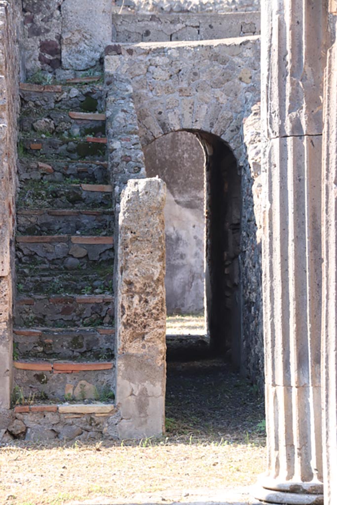 VI.7.21 Pompeii. October 2022. 
Staircase to upper floor, and corridor through arch to rear and linking with peristyle of VI.7.20.
Photo courtesy of Klaus Heese.