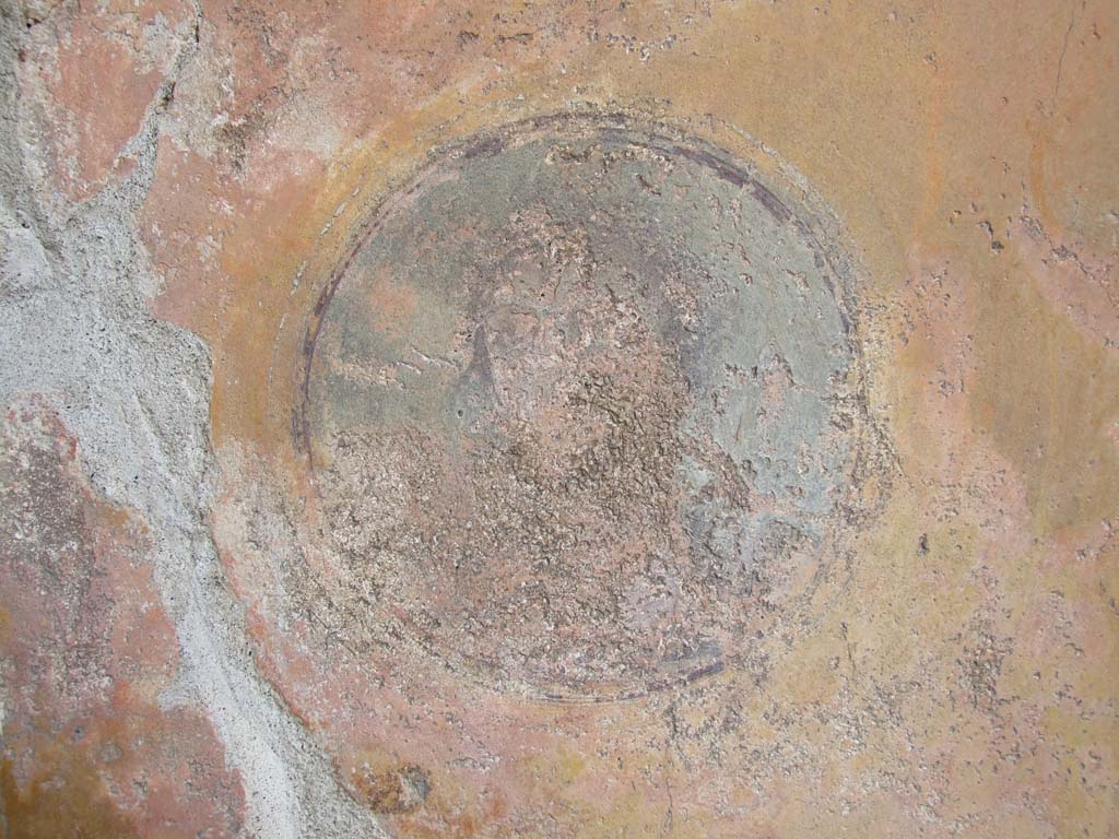 VI.7.23 Pompeii. December 2006. Detail of face on medallion from east end of north wall of tablinum.