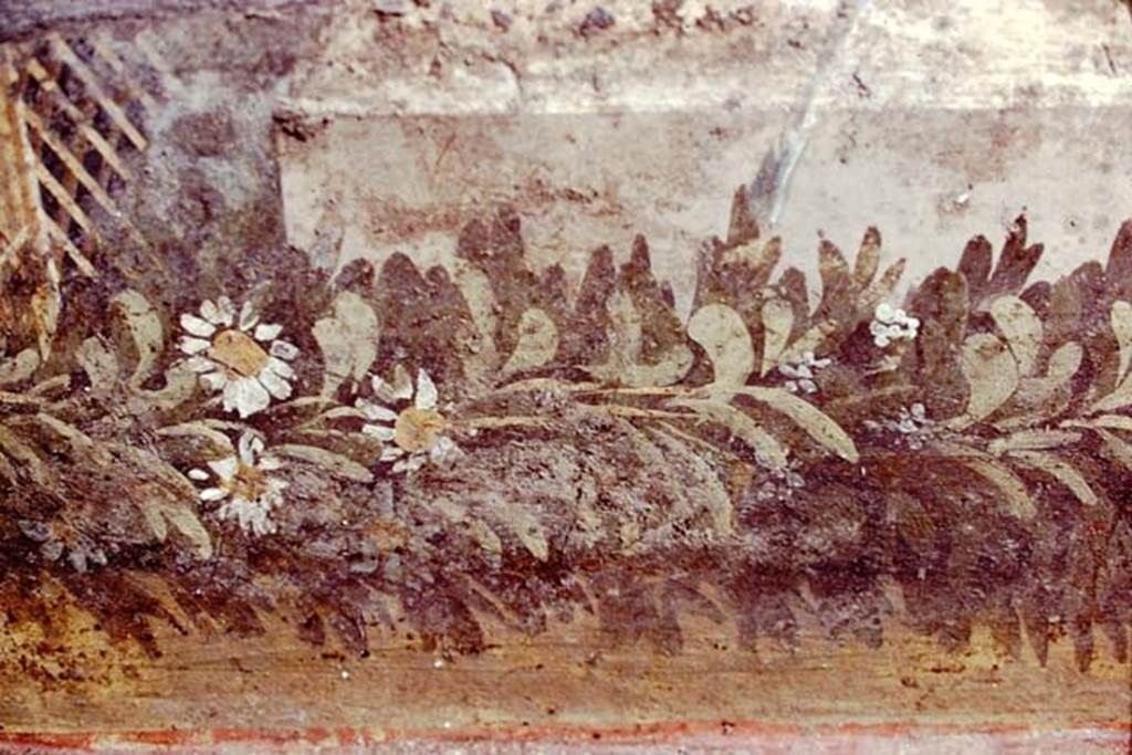 VI.7.23 Pompeii, 1978. Detail of remains of painted trellis and flower garland from south wall of courtyard, behind fountain.
Photo by Stanley A. Jashemski. 
Source: The Wilhelmina and Stanley A. Jashemski archive in the University of Maryland Library, Special Collections (See collection page) and made available under the Creative Commons Attribution-Non Commercial License v.4. See Licence and use details.
J78f0564