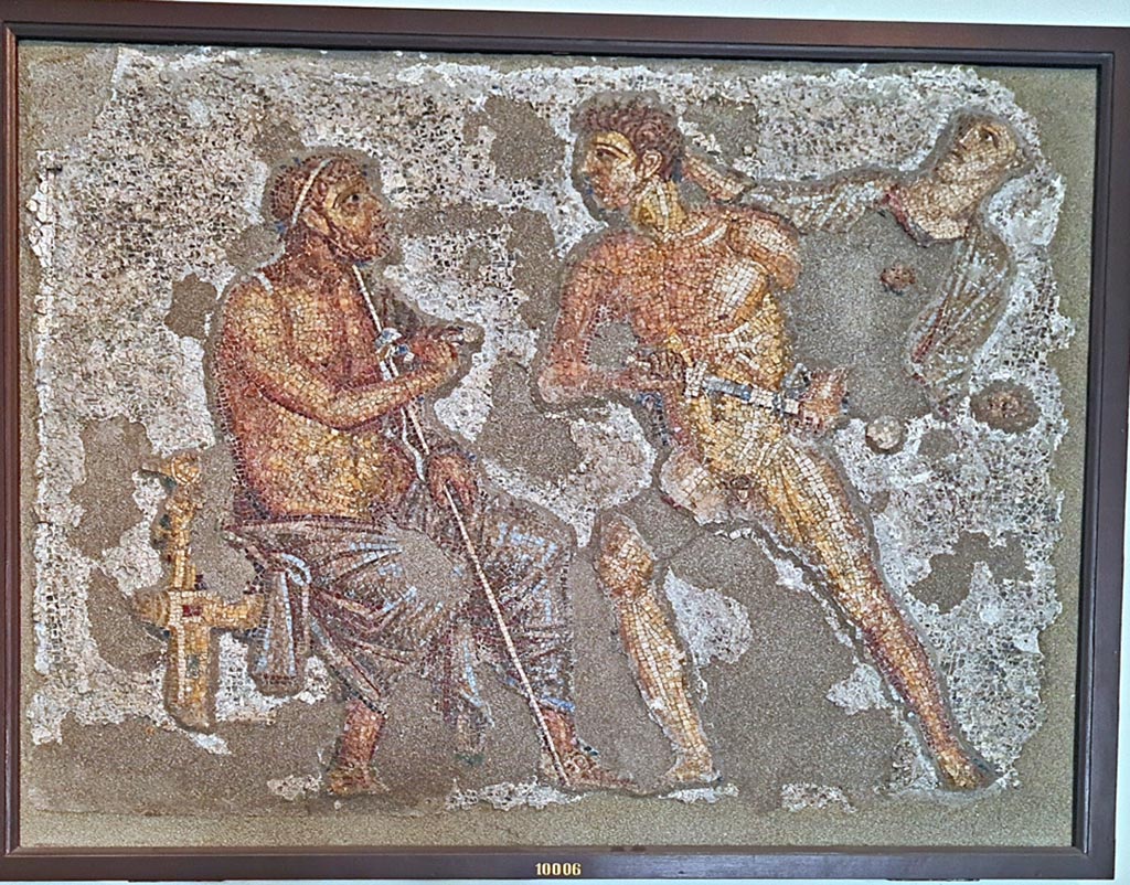 VI.7.23 Pompeii. September 2024.South side of garden portico. Mosaic of Achilles confronting Agamemnon.  
Now in Naples Archaeological Museum. Inventory number 10006.  Photo courtesy of Giuseppe Ciaramella.
According to the information card –
Achilles confronts Agamemnon. Polychrome wall mosaic made of limestone, glass paste and shells. 
Achilles, restrained by Athena, in his attempt to have Brisels returned to him, unsheathes his sword and approaches Agamemnon who is seated on a stool and looks startled. To the right, his beloved slave girl observes the scene in dismay.
(Third quarter of the Ist century AD.)
(Achille affronta Agamennone. Mosaico parietale policromo in calcare, pasta vitrea e conchiglia. 
Achille, trattenuto da Atena, per ottenere la restituzione di Briseide, sguaina la spada contro Agamennone, seduto su un sgabello e sorpreso. 
A destra, l’amata schiava osserva sconvolta la scena. Terzo quarto del I secolo d.C.)