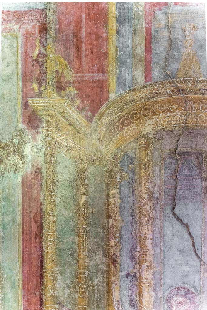 VI.7.23 Pompeii. July 2021. 
Detail of painted architectural detail from west wall of west alcove, above the head of Apollo.
Photo courtesy of Johannes Eber.