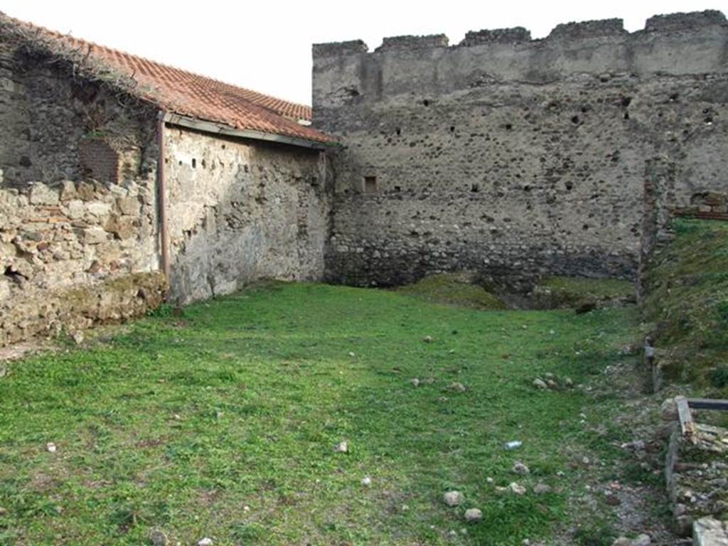 VI.9.1 Pompeii. December 2007. Looking south.
According to Jashemski, this area was the site of the spacious L-shaped garden of the Hospitium, room 18. It was excavated in 1830. On the west side of the garden was an exceptionally large triclinium, room 15, with windows onto the garden area. Remains of the wall with windows can be seen on the right of the photo.
See Jashemski, W. F., 1993. The Gardens of Pompeii, Volume II: Appendices. New York: Caratzas. (p.137)
According to Warscher, quoting Minervini in Bull. Napol. 1843, p.69, she described  –
“The open space of which we have already spoken, and to which one exits from the last described cubiculum, was perhaps used as a garden,  and onto which opened three large windows, one of which was from the already described cubiculum, and two were in the walls of the big room, (the large triclinium) as we have said, to the right of the atrium.  A masonry channel collected water that fell from the roof and carried it into a cistern, of which one could see the double mouth. Also in the wall in front of this garden were more windows intended to give light to a workshop at the back of the garden, of this same, we must investigate further.  Behind the already described channel was a spacious room in which we could see other cistern openings, however with whitewashed masonry and a black zoccolo. This room certainly supported the roof slope towards that channel: this room communicated with the atrium, and also had a doorway, which now could be seen walled up, with another room ... ...”
See Warscher, T, 1938: Codex Topographicus Pompejanus, Regio VI, insula 9: Pars prima, (see photographs nos: 21, 22 and 23), Rome, DAIR, whose copyright they remain.