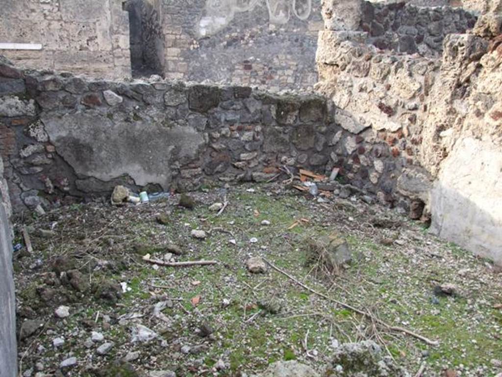 VI.9.1 Pompeii. December 2007. Room 21, looking west. According to Packer, in cubicula rooms 21, 20 and 19 (rooms 8, 7 and 6 on his plan) the decorations were once elaborate but only a few remnants survived.  In room 21 (or 8 on his plan), these walls would have been decorated with a white dado and the main wall areas were separated by red and yellow borders. In room 19 (or 6 on his plan), there were white panels with narrow red borders below a moulded stucco cornice. In room 20 (or 7 on his plan) there were yellow panels separated by red borders. According to BAN, the said bedrooms were all ornamented with dado, of both marble or black, and were painted with lines of plants, cornices, arabesques, birds often pecking the cherries or  fruits, panthers and other animals, and the areas above were mainly finished with elegant carved cornices of stucco.
See Cronache Pompeiane, IV, 1978, for article by Packer, J: Inns at Pompeii: a short survey (p.24-30)
See Bullettino Archeologico Napolitano, 1,1843, p.68-70
