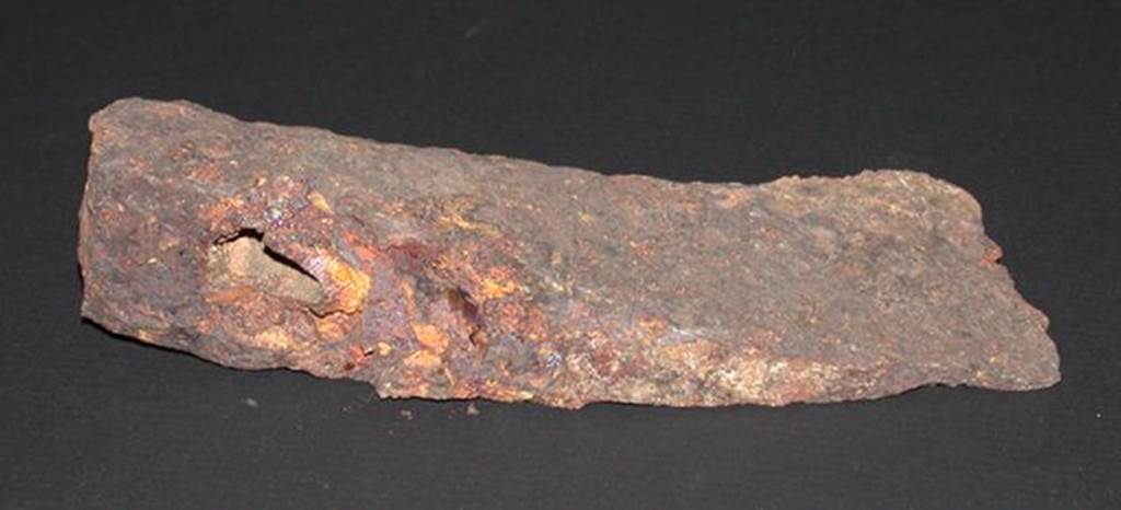 VI.9.1 Iron axe head, front view.  Height 0.033m, width 0.057m, length 0.14m.  OA 2811 Hache, musée Condé, photo RMN © R.G. Ojeda