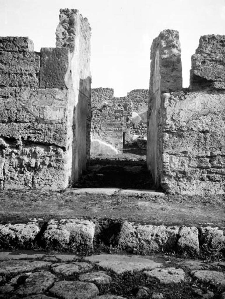 231030 Bestand-D-DAI-ROM-W.626.jpg
6.9.1 Pompeii. W 626 Entrance doorway, looking east.
Photo by Tatiana Warscher. With kind permission of DAI Rome, whose copyright it remains. 
See http://arachne.uni-koeln.de/item/marbilderbestand/231030 
According to Warscher, quoting Nissen, in the entrance corridor, on the left of the doorway, a square hole in the wall for fixing a bar to barrier the door, could be seen. The threshold of lavastone measured 0,55m in its breadth. The floor was of opus signinum of the later period. The two entrance corridor walls, 3,55m in length, still showed some miserable traces of paintings.
See Warscher, T, 1938: Codex Topographicus Pompejanus, Regio VI, insula 9: Pars prima, (no.5), DAIR, Rome.