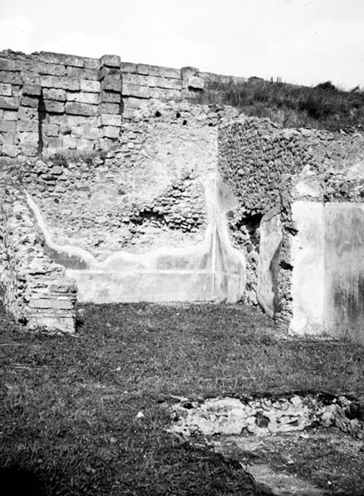 231233 Bestand-D-DAI-ROM-W.653.jpg
6.9.1 Pompeii. W653. Looking north across and impluvium towards oecus, room 12. 
Photo by Tatiana Warscher. With kind permission of DAI Rome, whose copyright it remains. 
See http://arachne.uni-koeln.de/item/marbilderbestand/231233 
According to Packer, the impluvium had been described as a rectangular basin with the short sides on the north and south sides. Originally it would have had a white marble rim. At the time of his writing in 1978, he stated that it had disappeared. Room12 would have had a red dado embellished with painted plants, above which was a deep red zone separated by yellow areas and arabesques.
See Cronache Pompeiane, IV, 1978, for article by Packer, J: Inns at Pompeii: a short survey (p.24-30)
See Bullettino Archeologico Napolitano, 1,1843, p.69