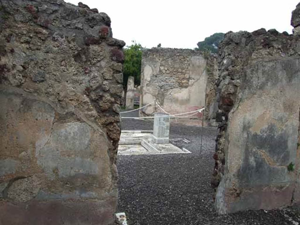 VI.9.2 Pompeii. May 2010. Room 13, north wall with doorway to south side of atrium.
According to PPM, the north wall was decorated with a red zoccolo, the middle zone of the wall was painted green, and the upper zone was white.