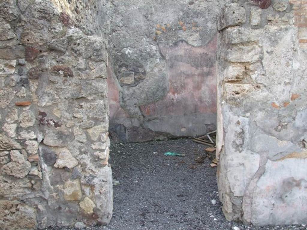 VI.9.2 Pompeii. December 2007. Doorway to room 14, cubiculum on south side of atrium.
According  to PPM, the walls were painted with a black zoccolo and a red middle zone with a glimpse of architectural decoration. The floor was of cocciopesto ornamented with white tesserae, which seemed to have been later modernised with the insertion of pieces of marble.