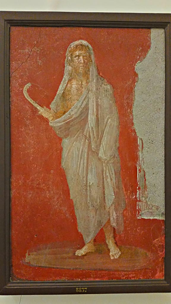 VI.9.6 Pompeii. Wall painting of Saturn or Chronos or Chronus holding a sickle.
One of two paintings that flanked the door in the deep bay of the atrium that formed a vestibule for the peristyle. 
Now in Naples Archaeological Museum. Inventory number 8837.
Photo courtesy of Giuseppe Ciaramella, November 2018.