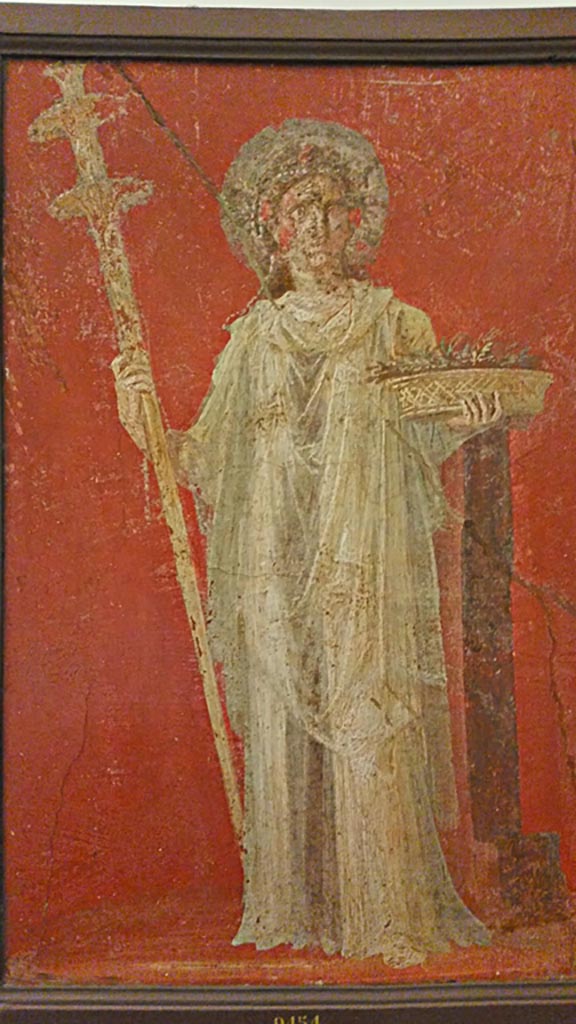 VI.9.6 Pompeii. 
Wall painting of Ceres holding a long torch and a basket full of ears of grain.
One of two paintings that flanked the door in the deep bay of the atrium that formed a vestibule for the peristyle. 
Now in Naples Archaeological Museum. Inventory number 9454.
Photo courtesy of Giuseppe Ciaramella, November 2018.