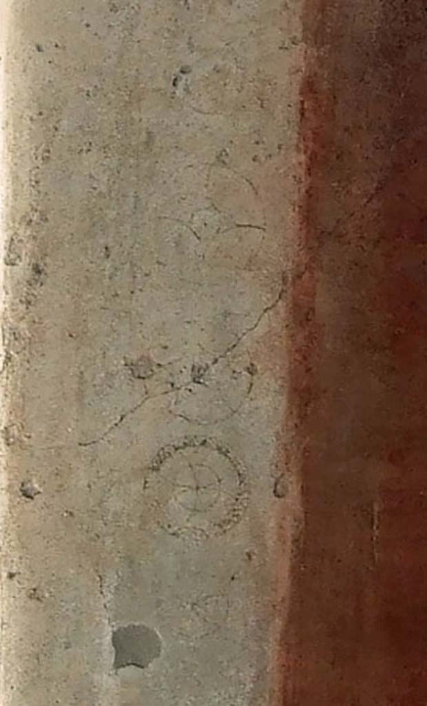 VI.9.6 Pompeii. March 2009. Room 13, south wall, west side of doorway. 
Detail of circular ornamental decorations on white plaster at edge of doorway.