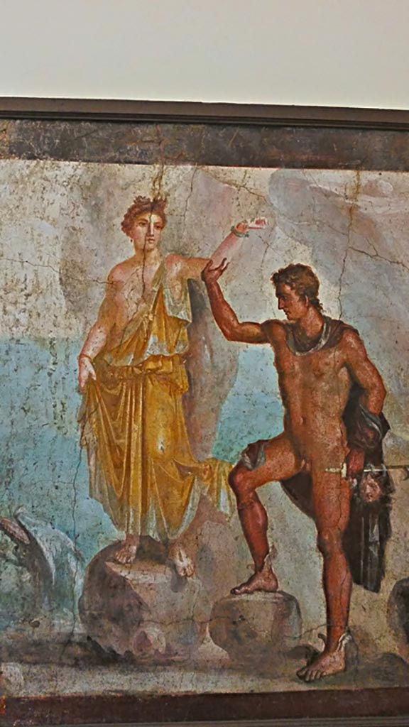 VI.9.6 Pompeii.  Wall painting of Perseus rescuing Andromeda.
According to the information card –
“Perseus and Andromeda: this is the largest version of a subject found many times in the decoration of the Vesuvian cities.
The hero helps the young girl to climb down the rock to which she had been chained. 
He holds a sword in his left hand and the recently severed head of the Gorgon.”
Now in Naples Archaeological Museum. Inventory number 8998.
Photo courtesy of Giuseppe Ciaramella, November 2018.