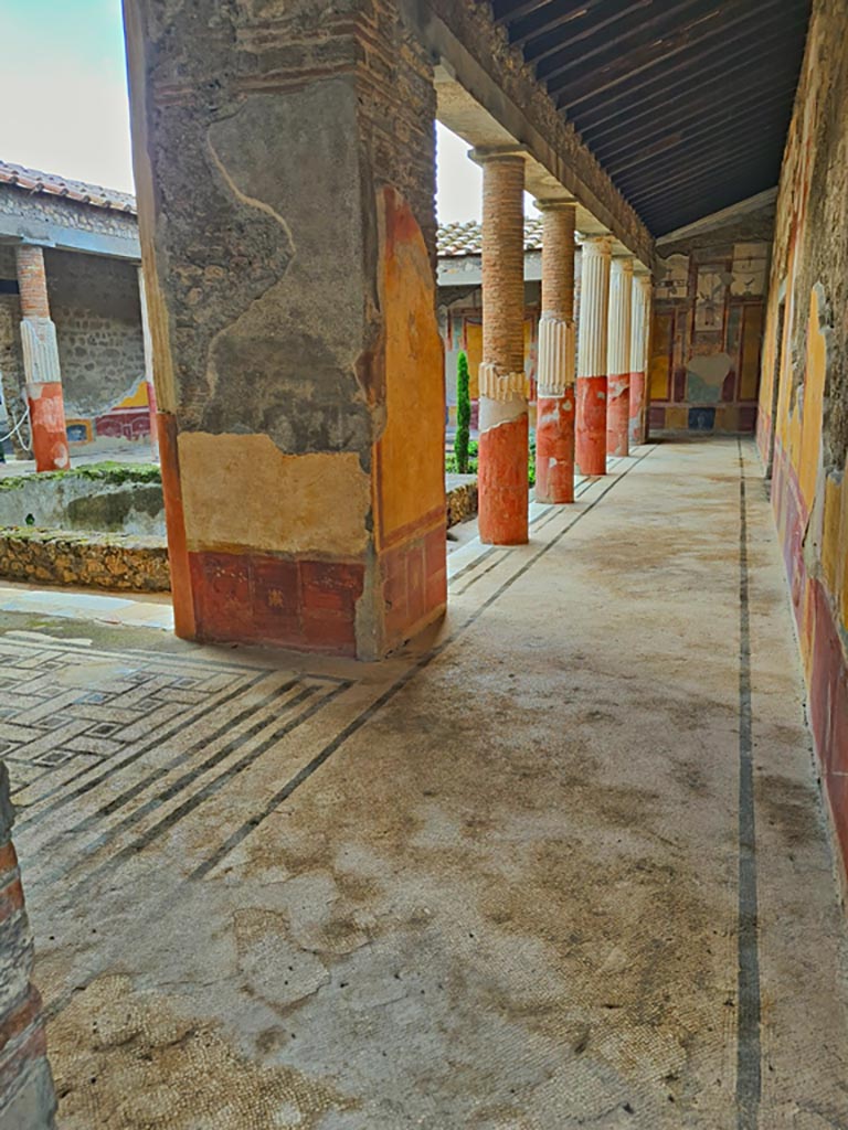 VI.9.6 Pompeii. November 2023. 
Room 6, looking west towards pilaster in north-east corner of peristyle, and along north portico.
Photo courtesy of Giuseppe Ciaramella.