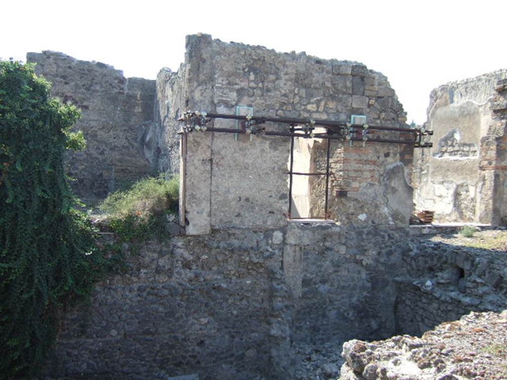 VI.9.11 Pompeii. March 2009. Looking towards rear doorway of tablinum of VI.9.5. Originally this doorway from the tablinum would have led to out onto a portico and rear garden 30. The triclinium on the north side of the tablinum, on the right, would also have led out onto the garden. According to Jashemski, Overbeck-Mau reported a pool on the right side of the garden. The garden, pool and portico are now completely destroyed due to a collapse of the vault of the cellar below. See Jashemski, W. F., 1993. The Gardens of Pompeii, Volume II: Appendices. New York: Caratzas. (p.138)