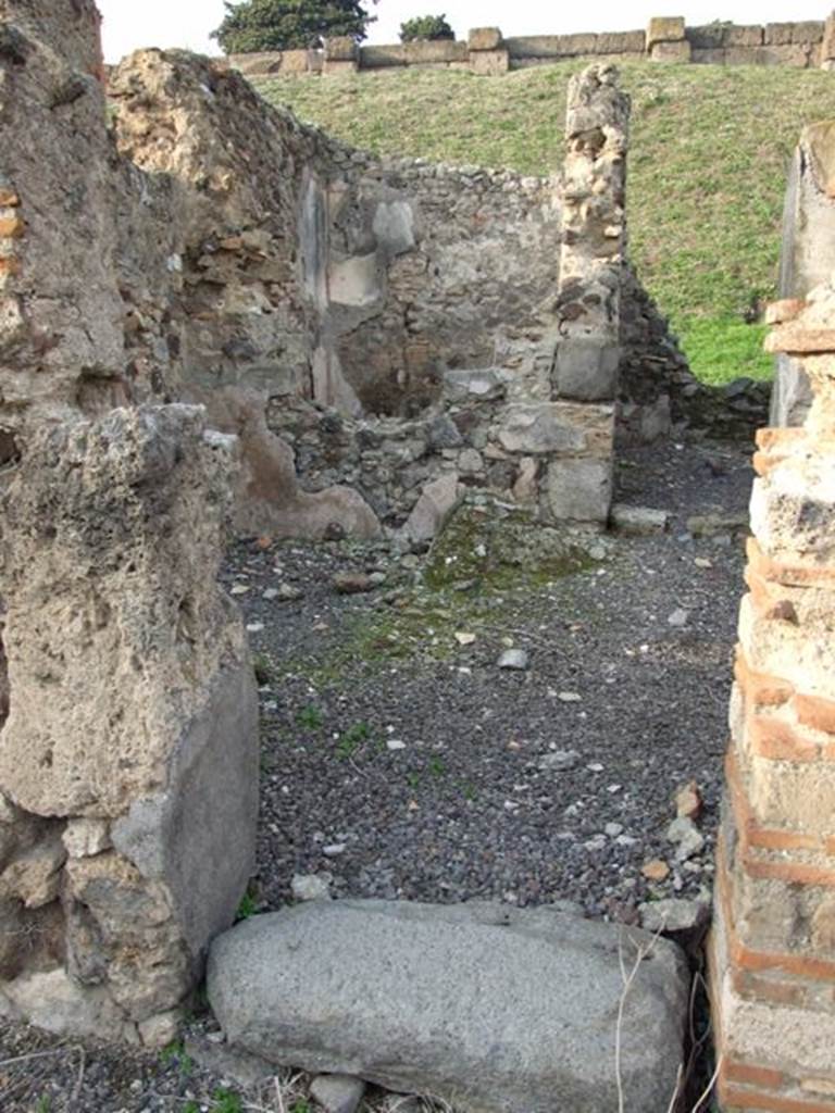 VI.9.14 Pompeii. December 2007. Corridor 29, leading to kitchen 28 in north-east corner.
At the rear of the site of the light-yard/courtyard, the small room 30 can be seen through the remains of a window. According to Packer, the wall plaster was painted red in the light-yard/courtyard area.
