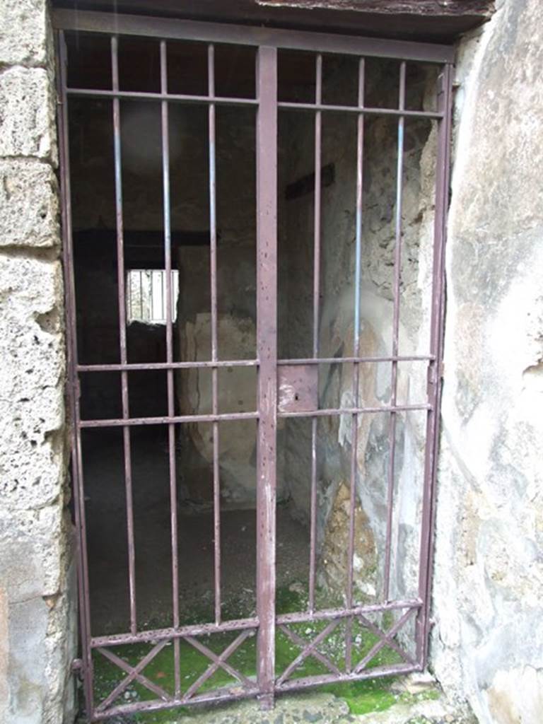 VI.10.1 Pompeii. March 2009. Doorway to two rooms on south side of east wall of bar-room.
According to Boyce, on the south wall beneath the stairs was a lararium painting: 
A single serpent about to devour the offerings – an egg and a pine cone – on a burning altar.
See Boyce G. K., 1937. Corpus of the Lararia of Pompeii. Rome: MAAR 14.  (p.50, no.180).
(Note: in Part 1 of VI.10.1, the lararium painting can be seen (courtesy of William Gell) against the west wall.)
According to Eschebach, near the stairs was the doorway into the two rooms on the south side.
See Eschebach, L., 1993. Gebäudeverzeichnis und Stadtplan der antiken Stadt Pompeji. Köln: Böhlau. (p.192)