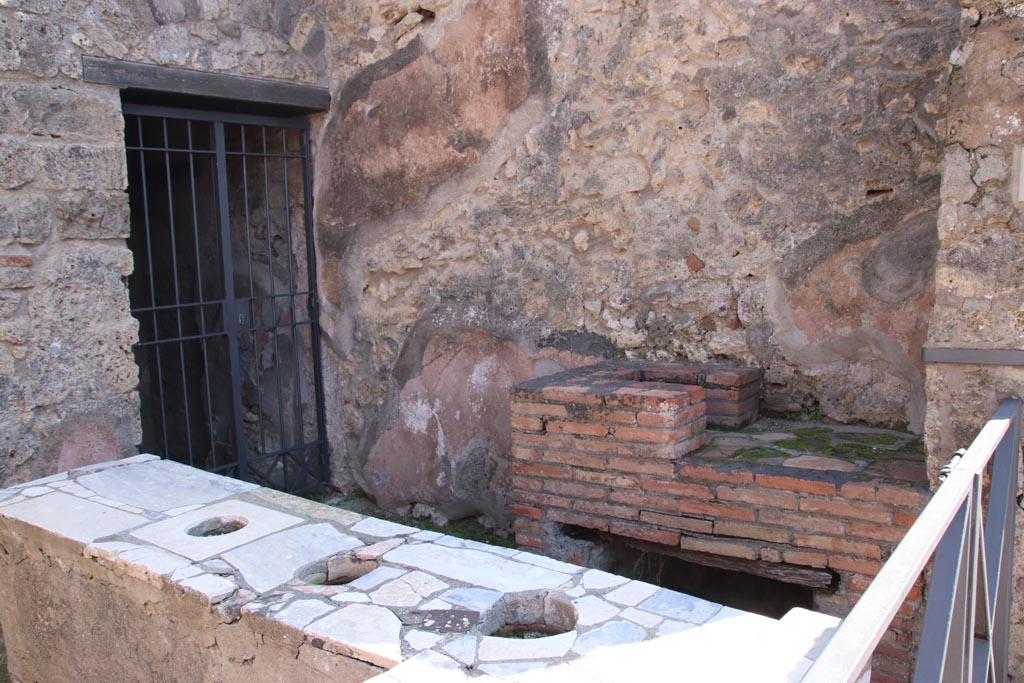 VI.10.1 Pompeii. October 2022. 
Looking towards south wall of bar-room with hearth and doorway to rear room on south side of bar-room. Photo courtesy of Klaus Heese.