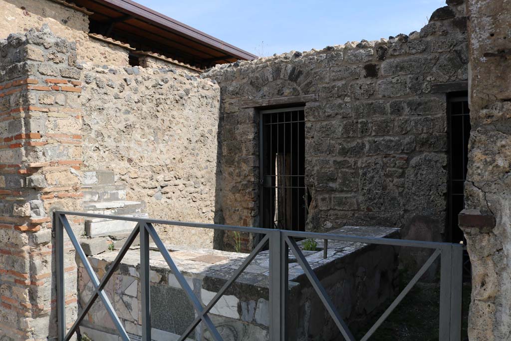 VI.10.1 Pompeii. December 2018. 
Looking north-east across counter in bar-room towards doorway to rear room. Photo courtesy of Aude Durand.