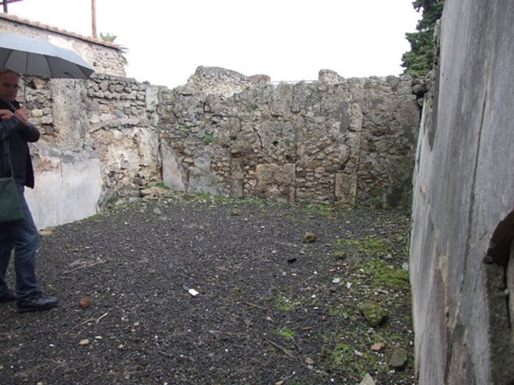 VI.10.2 Pompeii. March 2009. Oecus on north side of atrium, looking east.  According to Bragantini, the north wall of this room would have been decorated with a black dado. The middle zone of the walls was colourless but would have been panelled and with narrow compartments. The decoration on the south wall was completely illegible.
See Bragantini, de Vos, Badoni, 1983. Pitture e Pavimenti di Pompei, Parte 2. Rome: ICCD. (p.231, oecus 6)