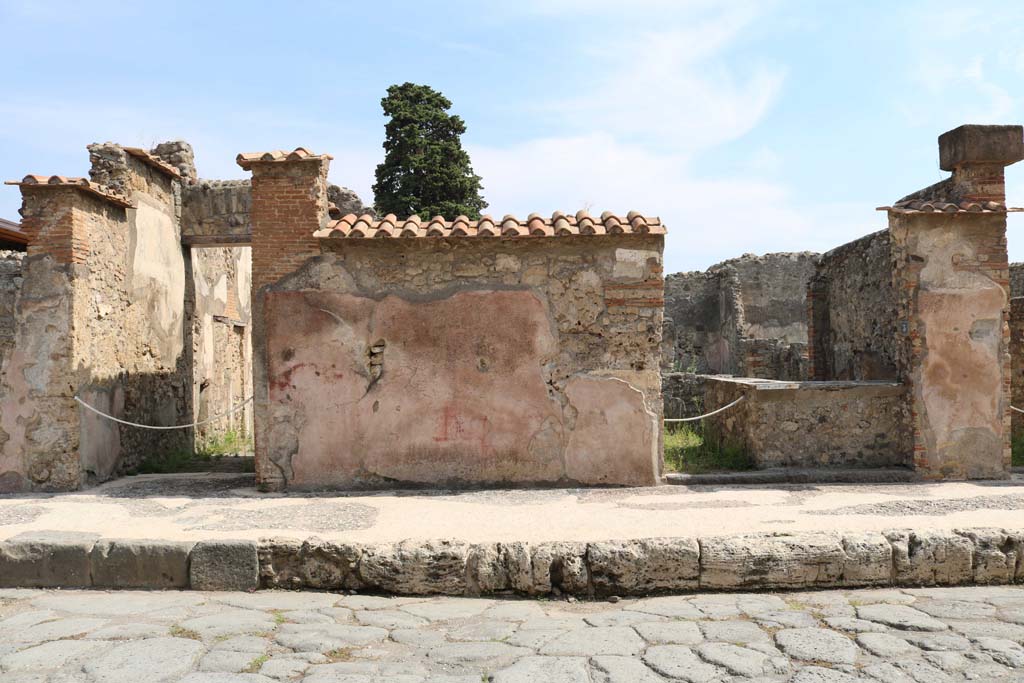VI.10.2 Pompeii, on left. December 2018. 
Looking east on Via di Mercurio towards front facade with painted plaster, with VI.10.3, on right. Photo courtesy of Aude Durand.