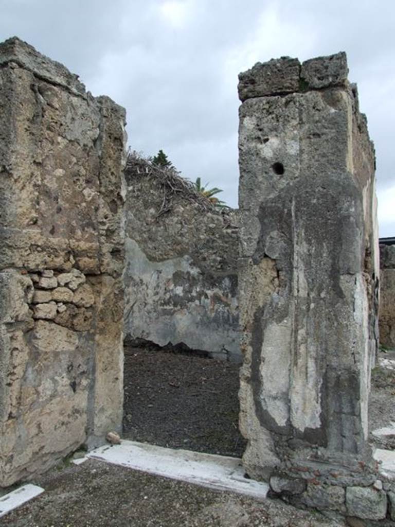 VI.10.7 Pompeii. March 2009. Doorway to room 7, on north side of tablinum. According to Bragantini, the walls of this room would have decorated with a dado which was faded and unrecognisable. The middle area of the walls was yellow, divided into panels.
See Bragantini, de Vos, Badoni, 1983. Pitture e Pavimenti di Pompei, Parte 2. Rome: ICCD. (p.232, ambiente 5)