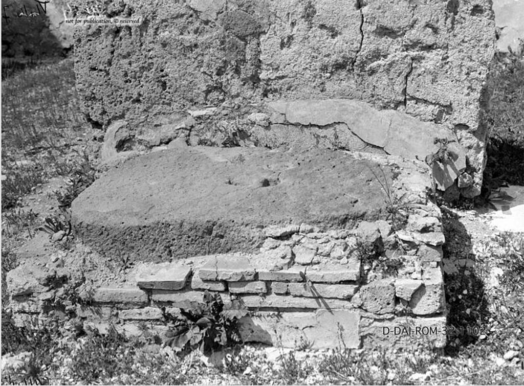 VI.10.7 Pompeii. 1932. 
According to Pernice –
The base is located in the atrium on the left wall between the central ala and the second room (there is a gap of 9-14 cm between the base and the wall). The base is a lava block with a not entirely regular wall made of clay and tuff bricks. 
Ancient treatments: To replace the old hole for the iron spike, which caused the stone to crack, a new hole was drilled right next to it.
See Pernice, E., 1932. Hellenistische Tische, Zisternenmündungen, Beckenuntersätze, Altäre u. Truhen. Berlin, p. 75, Taf. 45.2.
DAIR 32.1102. Photo © Deutsches Archäologisches Institut, Abteilung Rom, Arkiv. 
Thanks to Espen B. Andersson for assisting us in our interest in money-chests.