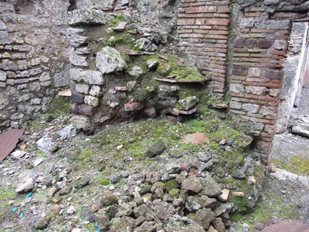 VI.10.11 Pompeii. March 2009. Room 13, partially collapsed masonry staircase to upper floor in kitchen area. The slabs of terracotta that formed the stair treads can be seen.