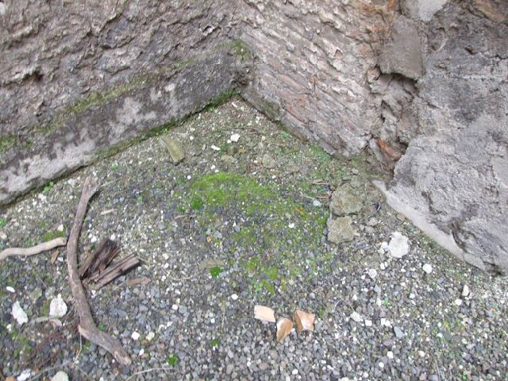 VI.10.11 Pompeii. March 2009. Room 16, north-west corner of oecus/triclinium.  According to Costantino, this room was a triclinium and would have had a floor of opus sectile containing slabs of marble which would have been the same as in the zoccolo. These were not present, perhaps they had been removed prior to the eruption and had not yet been re-applied. The preparation for their insertion again could be seen in the north-west corner of the room. The IVth style decoration was preserved only on the east and west walls of the room. The north and south walls contained two vast doorway entrances, which took up most of their walls.
See Costantino, C: L’apparato decorativo, in Rileggere Pompei, L’insula 10 della Regio VI, (2006), ed by Coarelli and Pesando, Rome: L”Erma” di Bretschneider, (p.299)