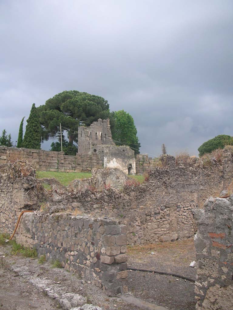 Vicolo del Fauno, Pompeii. May 2010. 
Looking north-east towards entrance to VI.11.4, and across to Tower X. Photo courtesy of Ivo van der Graaff.