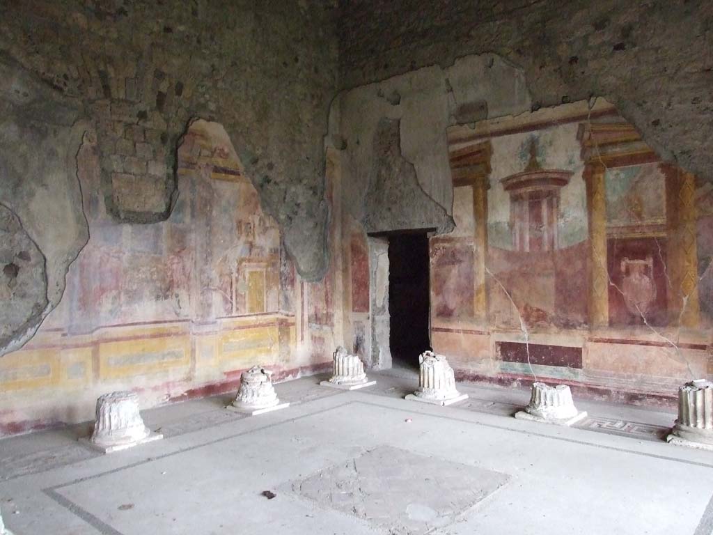 VI.11.10 Pompeii. December 2006. Room 43, looking north-east across Corinthian oecus.  
Remains of columns, painted walls and doorway to room 45 in north-east corner.