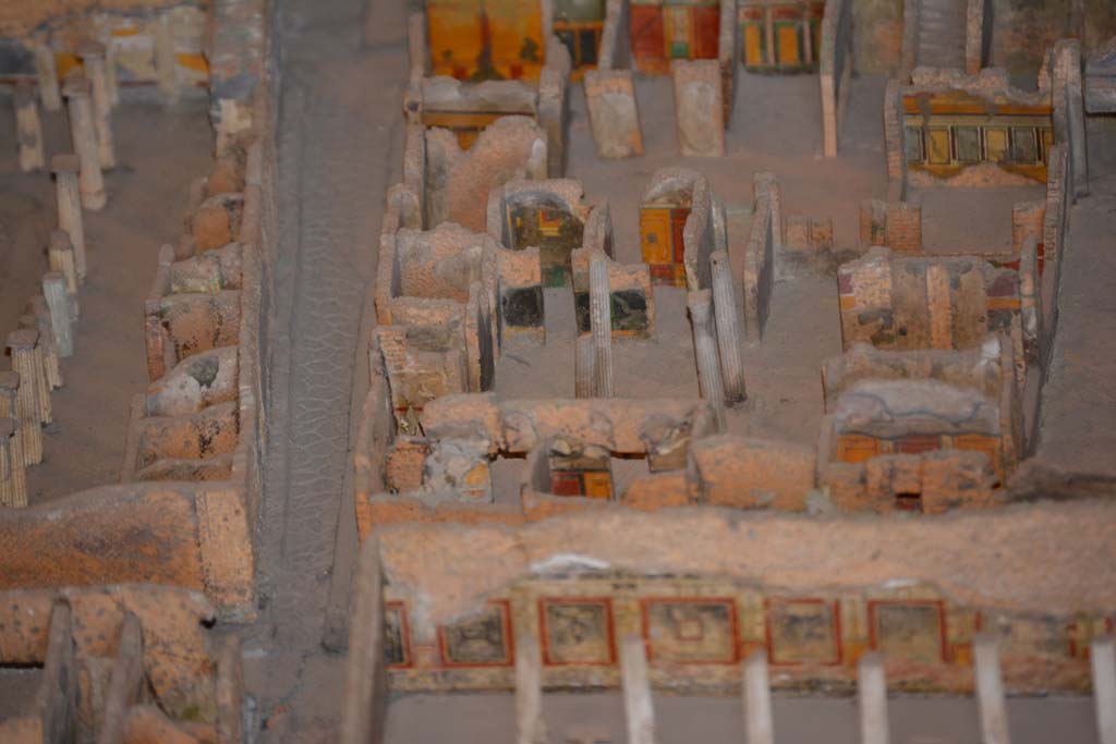 VI.11.9/10 Pompeii. July 2017. Top right, below the stairs, looking towards west wall of room 38, with window into room 35.
Beneath the window, the west wall of tablinum 33 can be seen. 
Across the centre, the west side of atrium 27 features the black painted room 28, the yellow/red painted room 29, undecorated corridor 48, and room 31, west ala.
From cork model in Naples Archaeological Museum.
Foto Annette Haug, ERC Grant 681269 DÉCOR.