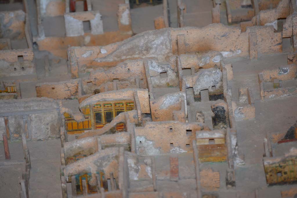 VI.11.9/10 Pompeii. July 2017. Looking west towards rooms at north end of peristyle 36.
On the left in the centre, the painted yellow/black wall of room 39 can be seen.
At the rear of it, on the right, the room 18.
On the right in the centre, the black painted walls, would appear to below to VI.11.8, and would mark the north boundary of this combined house. 
From cork model in Naples Archaeological Museum.
Foto Annette Haug, ERC Grant 681269 DÉCOR