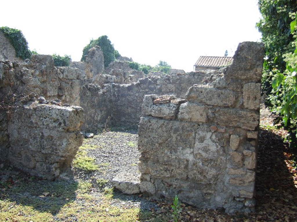 VI.11.15 Pompeii. September 2005. Closed tablinum on west side of atrium, with corridor to rear kitchen, on right.
According to Boyce, at the end of the corridor, were to be seen the ruins of a structure enclosing a rectangular niche.
The inside walls were coated with white stucco.
Here was probably the lararium described in the report as –
“un piccolo masso di fabbrica, forse ara, ed una piccolo nicchia, per cui potrebbe credersi un sacrario”.
His reference was – Bull. Arch. Nap., i, 1843, 74.
See Boyce G. K., 1937. Corpus of the Lararia of Pompeii. Rome: MAAR 14. (p.51, no.187)
See Giacobello, F., 2008. Larari Pompeiani: Iconografia e culto dei Lari in ambito domestico. Milano: LED Edizioni. (p.294)