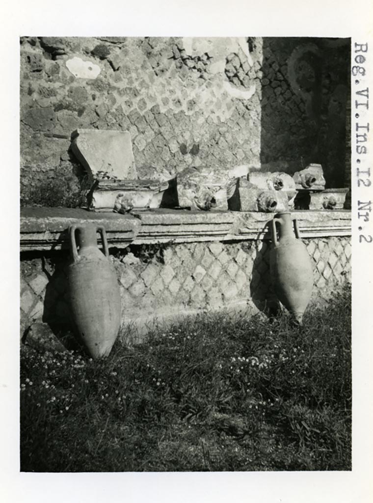 VI.12.2 Pompeii. Pre-1937-39. Amphorae and water-spouts on display, on north side of rear peristyle. 
Photo courtesy of American Academy in Rome, Photographic Archive. Warsher collection no. 36.