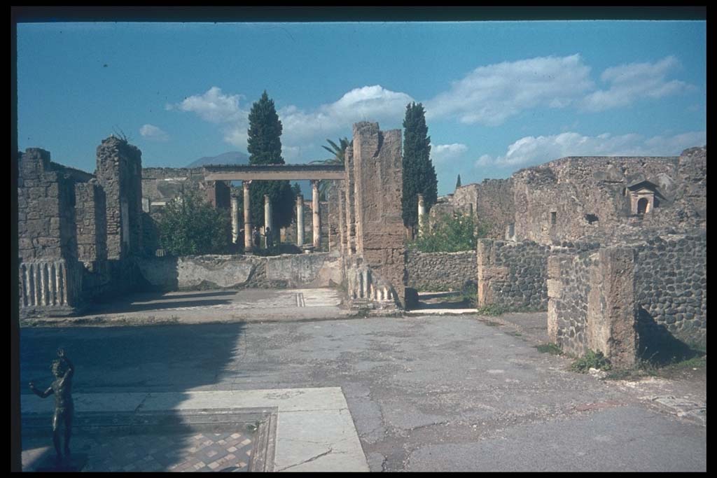 VI.12.2 Pompeii. Looking north across east side of atrium.
Photographed 1970-79 by Günther Einhorn, picture courtesy of his son Ralf Einhorn.
According to Garcia y Garcia, two bombs fell on this house in 1943. 
One caused the destruction of three rooms to the north-east of the Tuscanic atrium, then causing damage to other areas.
The loss of 1st style painting on the north and east walls of the atrium, and on the dividing wall of two cubicula to the west of these.
The mosaic floor was also damaged.
In a cubiculum in the south-east of the atrium, there was a total loss of the 2nd style painting.
In the other two cubicula on the east side, there was a total loss of the 1st and 4th style decoration.
The floor of the centre of the atrium also suffered damage.
The other bomb fell on the secondary atrium, see VI.12.5.
See Garcia y Garcia, L., 2006. Danni di guerra a Pompei. Rome: L’Erma di Bretschneider. (p.82-85, with photos)