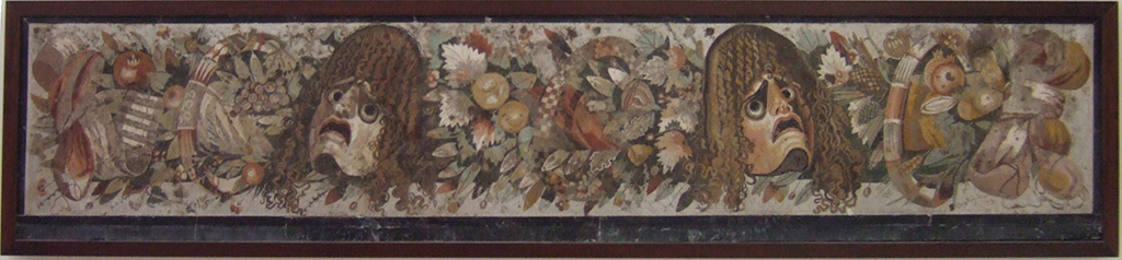 VI.12.2 Pompeii. Mosaic of two tragic masks between a group of flowers, fruits and garlands. 
Found in VI.12.2 as a threshold dividing the fauces (room 53) from the atrium, on 28th October 1830. 
See Mau, A., 1907, translated by Kelsey F. W. Pompeii: Its Life and Art. New York: Macmillan. (p. 290).
Now in Naples Archaeological Museum. Inventory number 9994.
According to Fiorelli, the tablinum 33 was also separated from the atrium, by a mosaic threshold of masks and garlands.
He described this as reputed to be one of the most stupendous works of art, due to the excellence of the design, colours and workmanship.
See Pappalardo, U., 2001. La Descrizione di Pompei per Giuseppe Fiorelli (1875). Napoli: Massa Editore, (p.71)
See PAH II, 240.