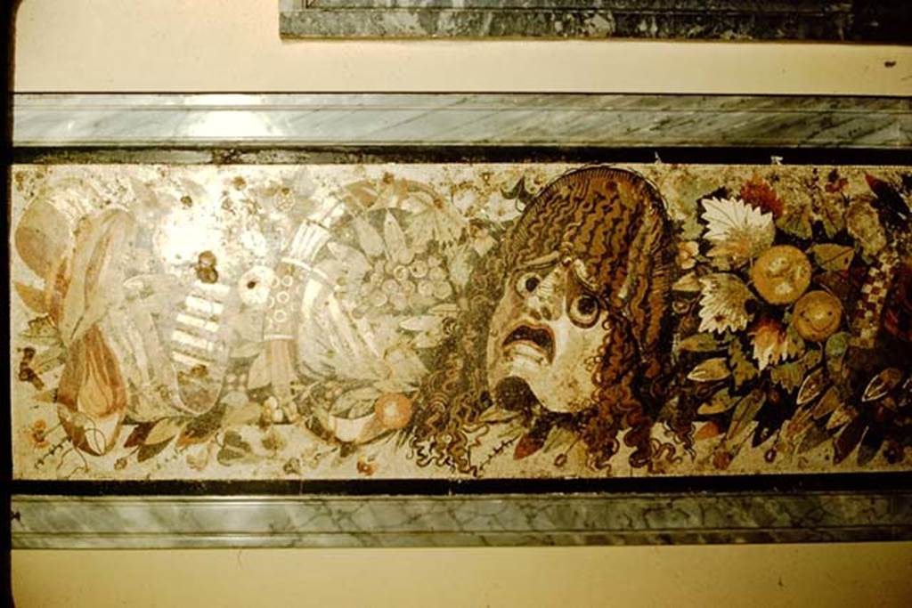 VI.12.2 Pompeii. 1957. Detail from mosaic of two tragic masks, with fruits, flowers and garlands.  Photo by Stanley A. Jashemski.
Source: The Wilhelmina and Stanley A. Jashemski archive in the University of Maryland Library, Special Collections (See collection page) and made available under the Creative Commons Attribution-Non Commercial License v.4. See Licence and use details.
J57f0530