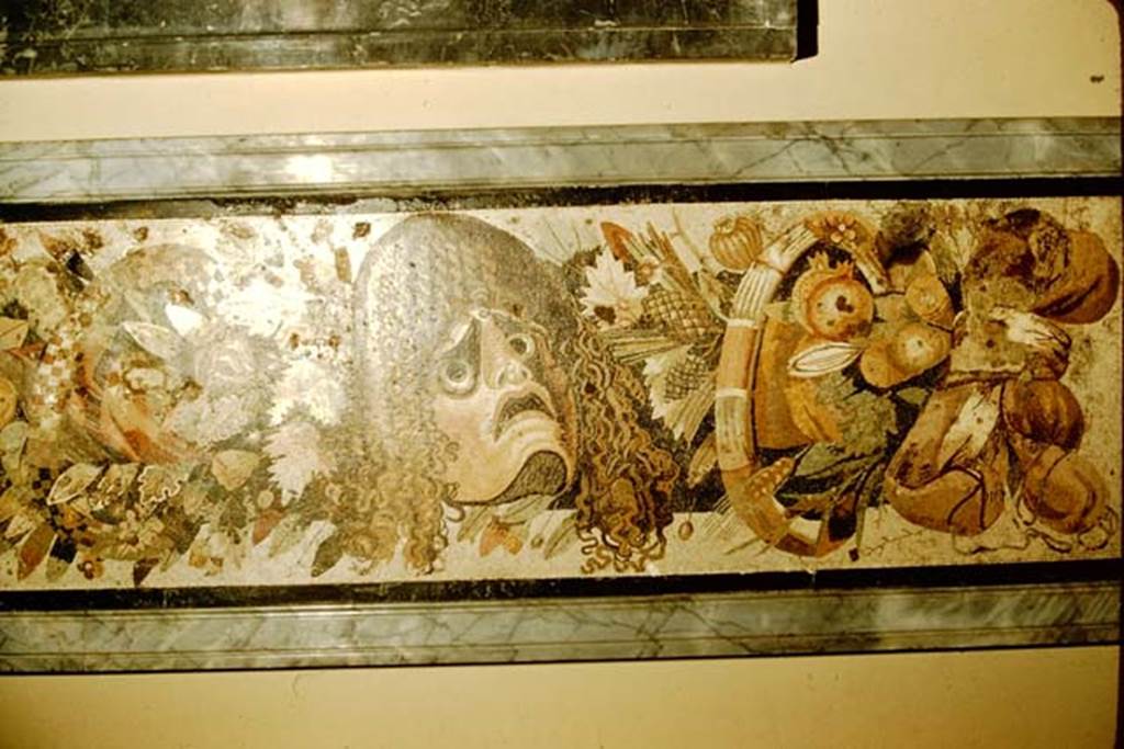 VI.12.2 Pompeii. 1957. Detail from mosaic of two tragic masks, with fruits, flowers and garlands.  Photo by Stanley A. Jashemski.
Source: The Wilhelmina and Stanley A. Jashemski archive in the University of Maryland Library, Special Collections (See collection page) and made available under the Creative Commons Attribution-Non Commercial License v.4. See Licence and use details.
J57f0531