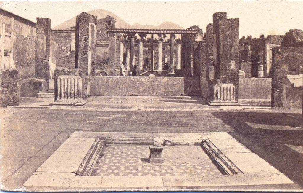 VI.12.2 Pompeii. Between 1867 and 1874. 
Looking north across impluvium in atrium, towards tablinum 33. Photo by Sommer and Behles. Photo courtesy of Charles Marty.
Found in the rooms on either side of the tablinum were floor mosaics.
According to Fiorelli, in the room on the left of the tablinum, giving access through to the peristyle, was found a mosaic of Bacchus on a panther. 
In the room on the right of the tablinum, was found a floor mosaic of a sea of fishes.
See Pappalardo, U., 2001. La Descrizione di Pompei per Giuseppe Fiorelli (1875). Napoli: Massa Editore, (p.71).