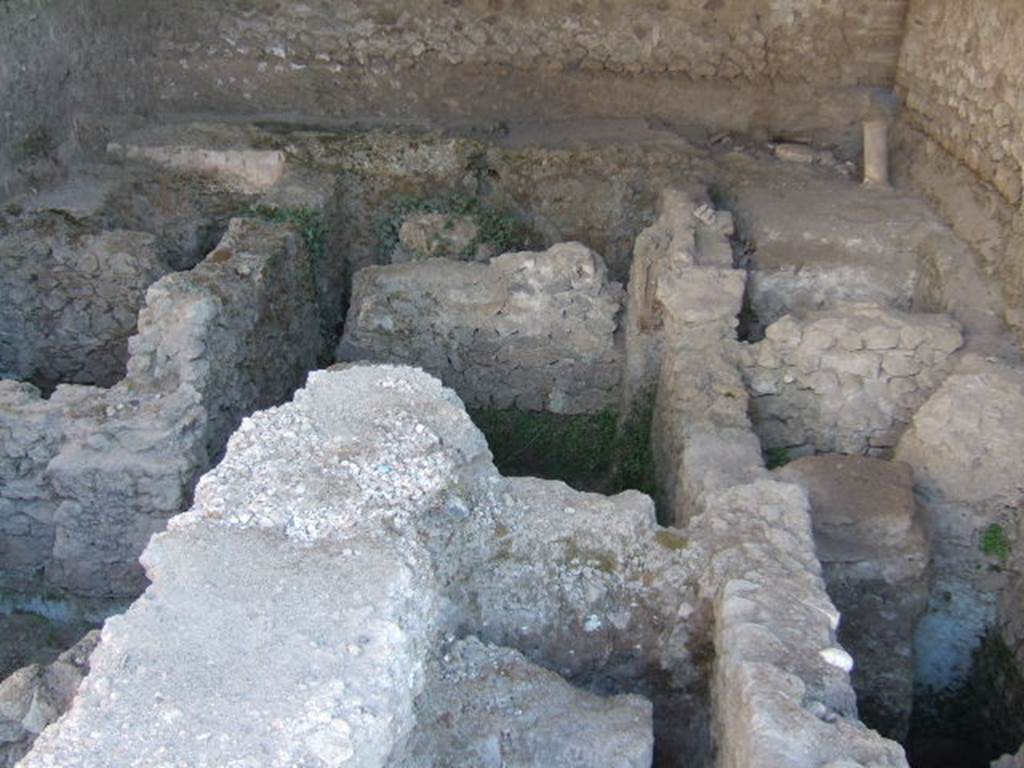 VI.12.2 Pompeii. September 2005. Oecus in south-east of second or rear peristyle. 
The excavation visible inside the oecus has brought to light the suspensurae and the wall cavity tubing of a pre-existing caldarium.
See Carratelli, G. P., 1990-2003. Pompei: Pitture e Mosaici. Vol. V. Roma: Istituto della enciclopedia italiana, p. 128.
