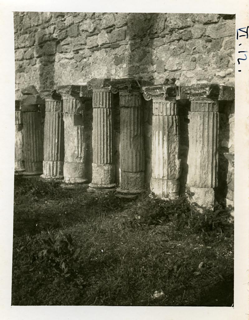 VI.12.2 Pompeii. pre-1937-39. Remains of columns and capitals against east wall of rear peristyle.
Photo courtesy of American Academy in Rome, Photographic Archive.  Warsher collection no. 1422.