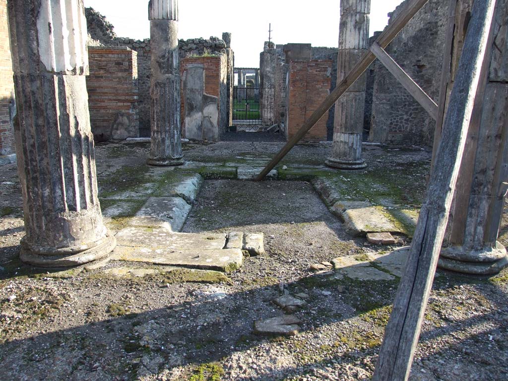 VI.12.5 Pompeii. December 2006. Looking south across impluvium and atrium 7 to entrance.
According to Garcia y Garcia, the second of the two bombs to hit the House of the Faun fell on this secondary atrium.
The bomb caused the felling of three of the four columns, the only one remaining was that in the north-east corner.
Also destroyed were two rooms in the north-west of the same atrium.
See Garcia y Garcia, L., 2006. Danni di guerra a Pompei. Rome: L’Erma di Bretschneider. (p.83-84)