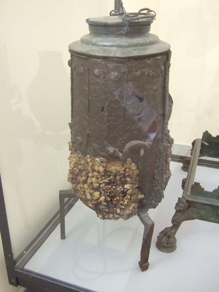 VI.12.5 Pompeii. Iron stove with bronze lid. 
Found in VI.12.2/5 on 21st March 1831 in a room around the atrium of the four columns (VI.12.5)
Now in Naples Archaeological Museum. Inventory number 264932.
See Fiorelli G., 1862. Pompeianarum antiquitatum historia, Vol. 2: 1819 - 1860, Naples, p. 249
