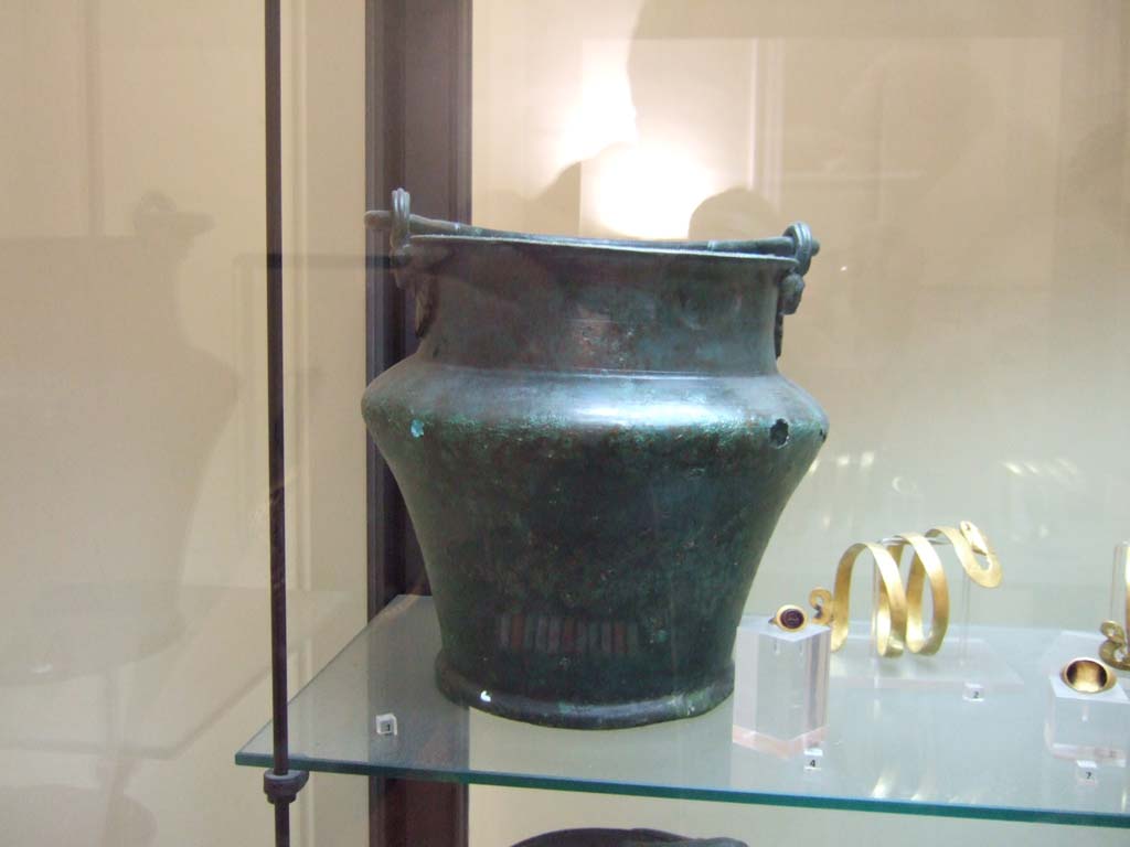 VI.12.5 Pompeii. Found in VI.12.2/5 on 21st March 1831 in a room around the atrium of the four columns (VI.12.5). 
Bronze situla or bucket. Now in Naples Archaeological Museum. Inventory number 68859.
See Fiorelli G., 1862. Pompeianarum antiquitatum historia, Vol. 2: 1819 - 1860, Naples, p. 249.